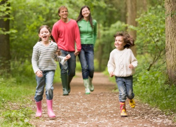 Fun autumn activities with the kids for half term - family walking in woods
